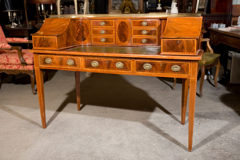 Mahogany and satinwood inlay desk with leather top and curved back. Upper section is fitted with drawers and doors. Tapered legs