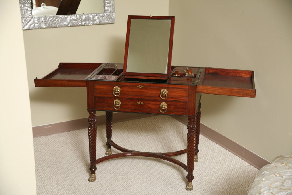 Beautiful gentlemen's dressing table/coiffeuse. Highest quality mahogany. The top opens to reveal a mirror that raises up and slides forward and backward. There are several storage places for bottles etc and the structure of this furniture itself is