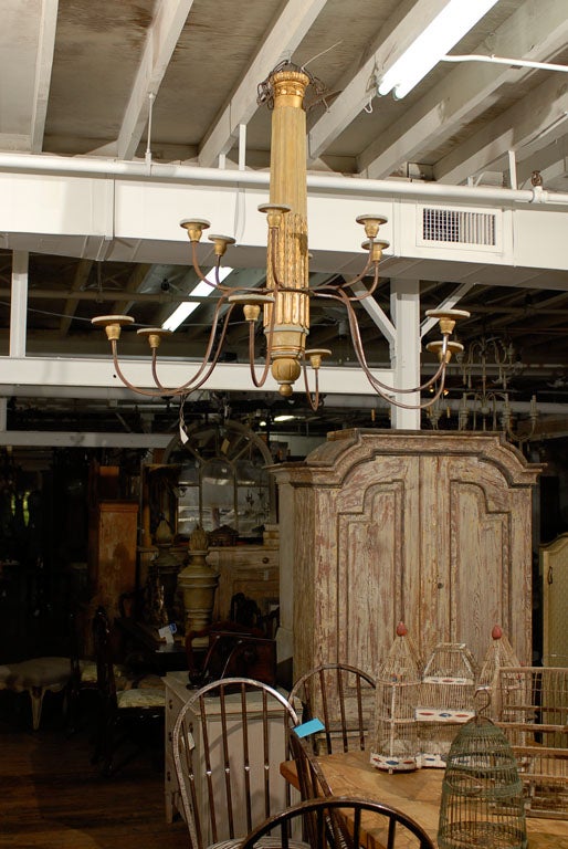 An Antique Four-Post Italian Bed made into a 12-arm chandelier.
This chandelier is composed of 20th C. and 21st C. elements
This item is not wired, making it easier to ship as the arms are removable.
