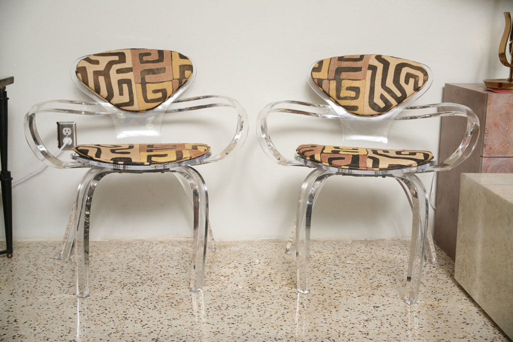 A unique twist on the classic Cherner bentwood design, these custom acrylic chairs feature vintage Kuba cloth upholstery.