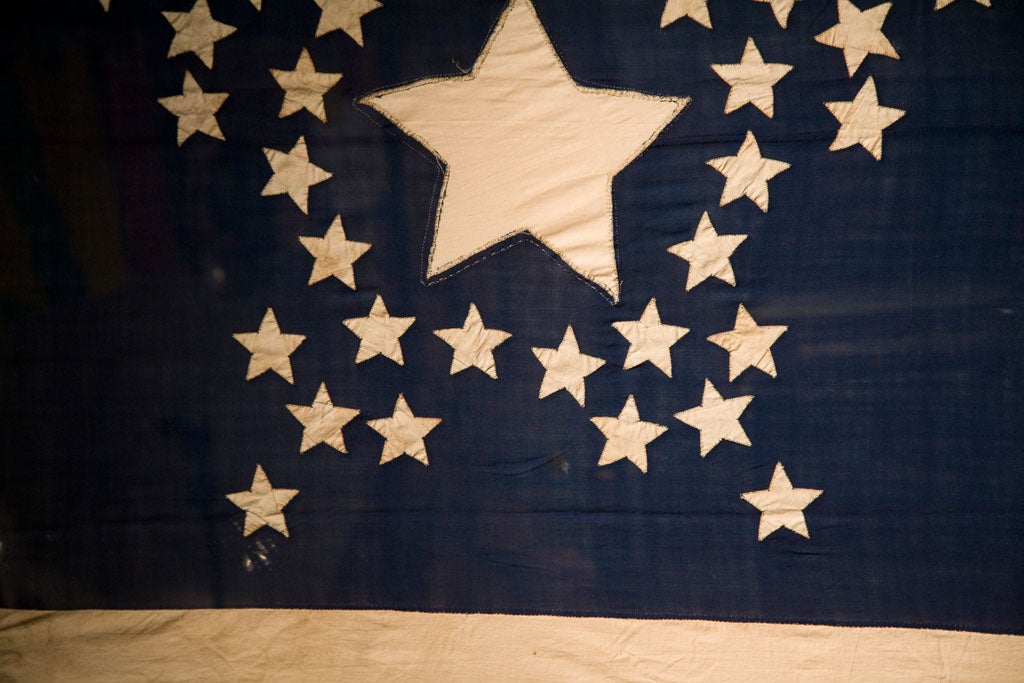 Very rare American flag masterpiece.  This flag was hand-stitched by Sarah Elizabeth Young Lee, who was said to have started work on the flag sometime before her marriage in 1852.  Sarah Elizabeth finished the flag in 1865, after Nevada's admission