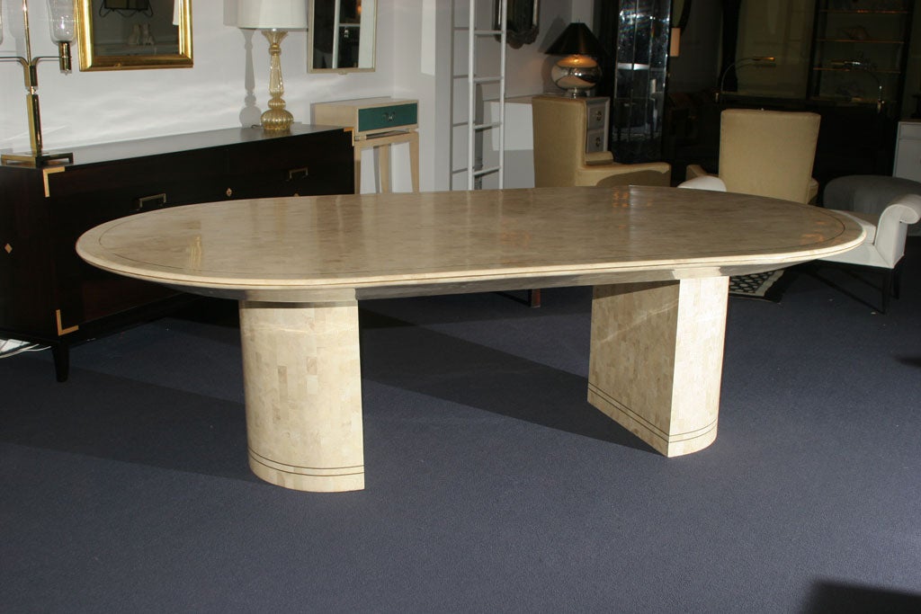 Powerful Karl Springer oval dining table in white fossilized coral with brass <br />
inlay detail. Mint condition.