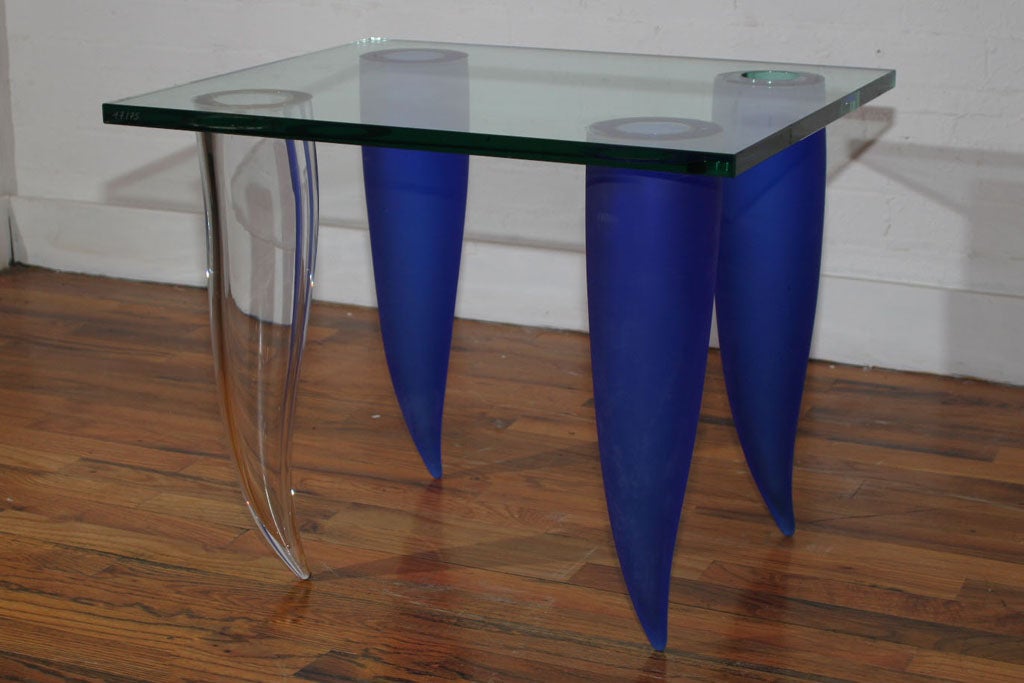 The Vase End Table. Has a abstract design that is truly a work of art. Its creative look consist of vase shaped legs including a opening through its 3/4 inch thick glass to insert live plants or anything that fits your needs that will add to this