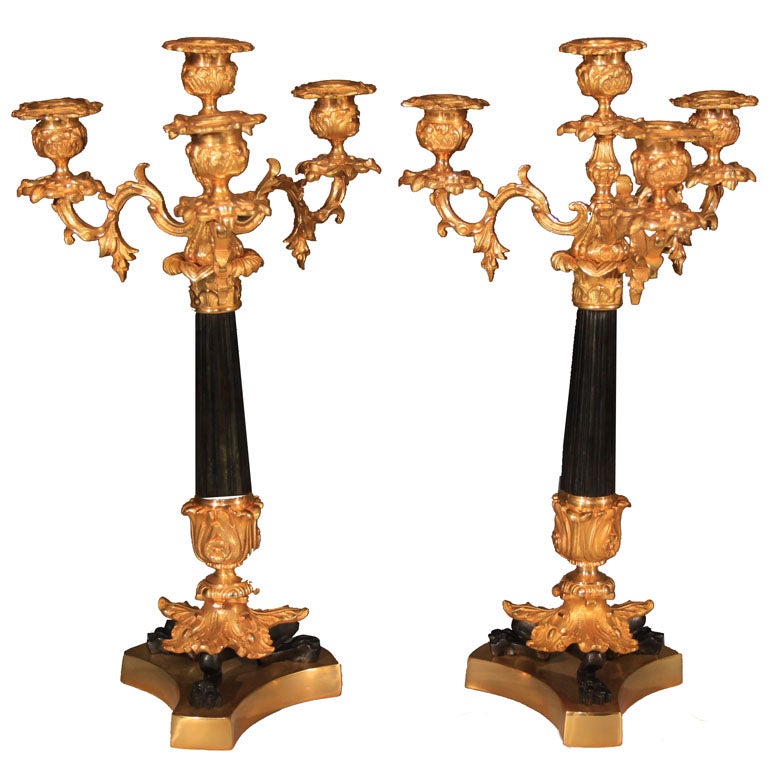 Pair of gilt 4 light candelabra. Claw feet on pedestal.