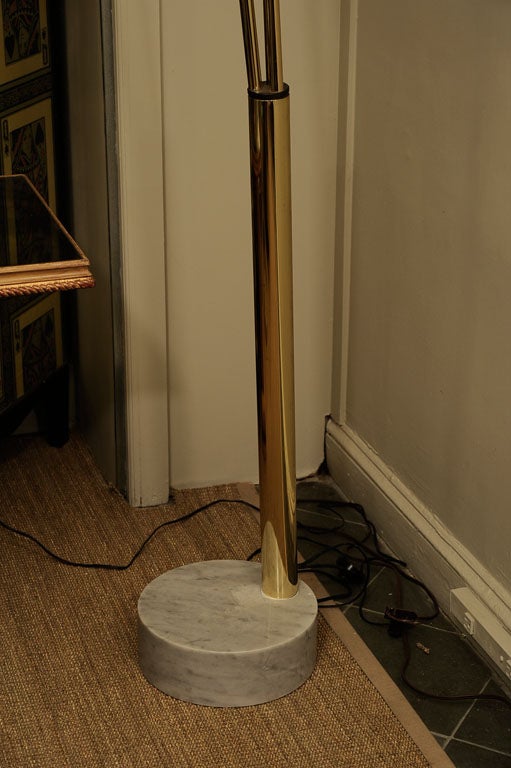 Attractive Brass Lamp has three arching arms and a marble base.