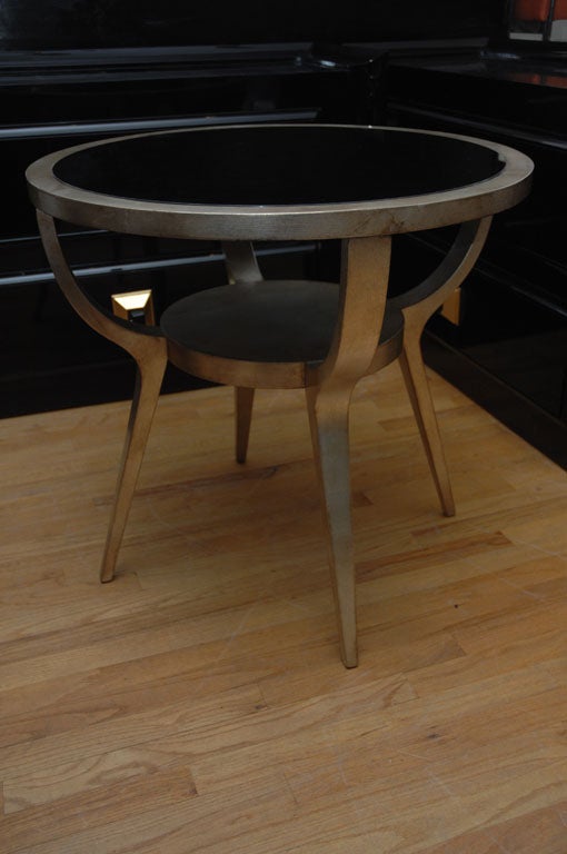 Elegant side table in a beautiful glazed silver leafed finish by JAMES MONT. The table has a black mirrored top
