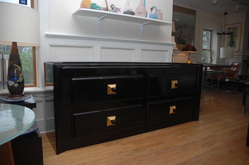 Stunning large high gloss black lacquered cabinet with gold leaf pulls by James Mont. The cabinet has been fully restored and is spectacular it has four drawers with wonderful gold leaf pulls.
There are a pair available and they are priced