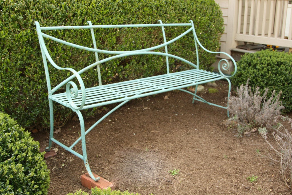 A rare find today, this classic Regency wrought iron bench has curled ears, arms, and feet.  In a lovely worn robins egg blue, it would make an exceptional addition to any garden. Airy, yet with real presence, this 3-seater makes for an elegant