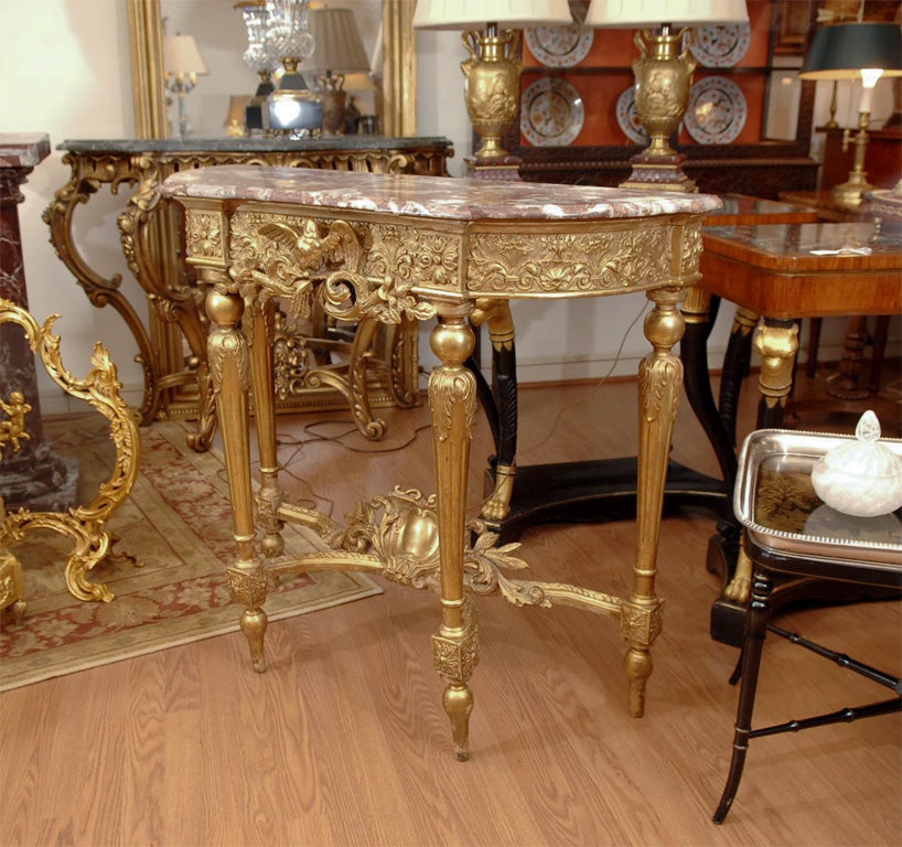 19th Century Louis XVI gilded and hand carved, marble topped console. Beautiful detail with a stretcher base