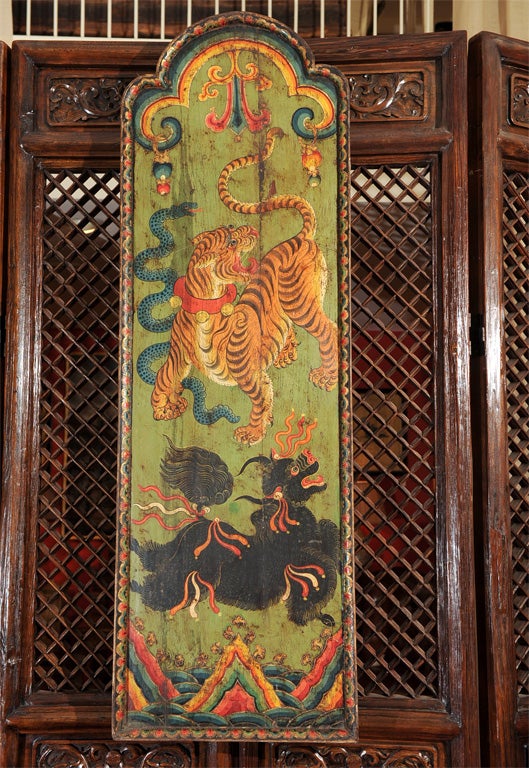 A very unusual door from Tibet depicting a crouching tiger and foo dog.
