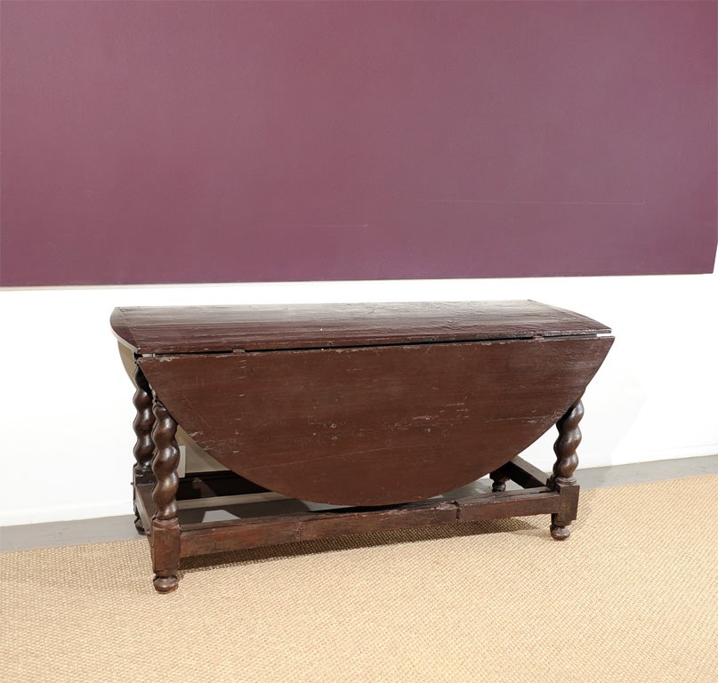 Handsome drop-leaf table with twisted legs that are split in half when open.