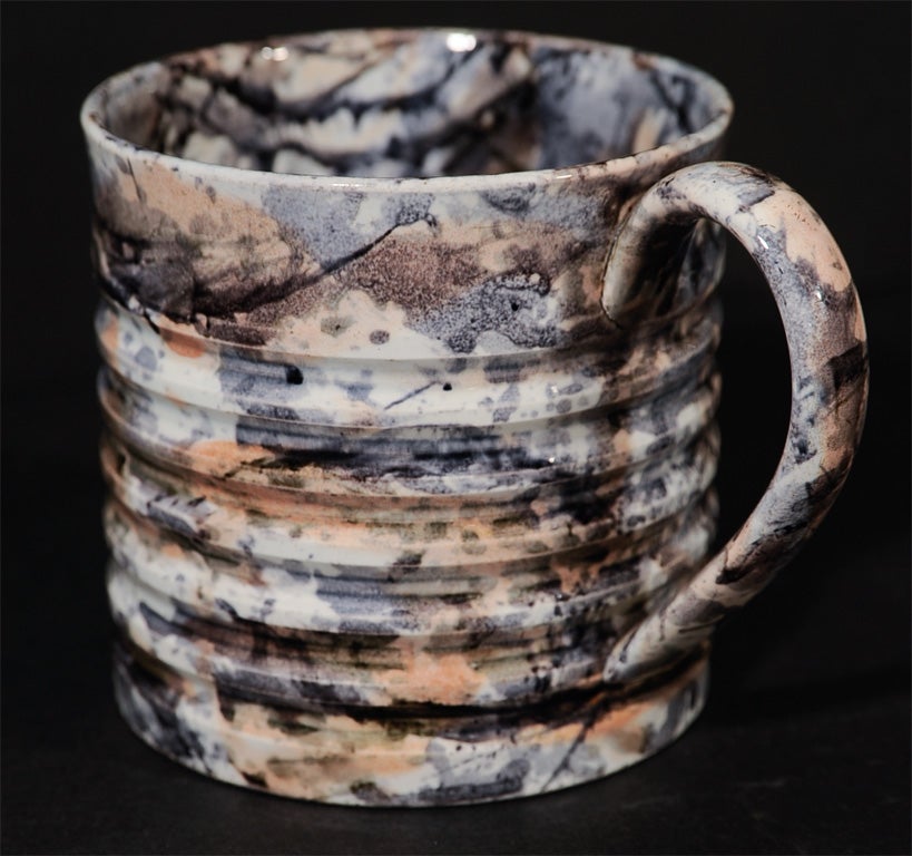 An English pearlware pottery mug with machine turned horizontal ribs.
 Made in the 1830s the mug has a surprising modern, Jackson Pollock type look.