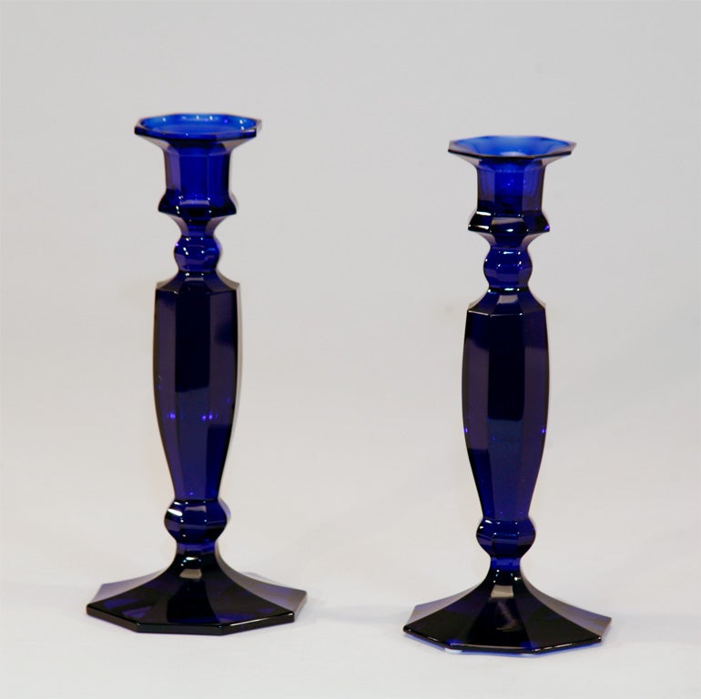 Hand blown cobalt blue crystal candlesticks with panel cutting, matching from the foot to the bobeches. Beautiful deep blue rich blue crystal varies in intensity as it moves upward to the top, where the light shines through. Classical form goes with