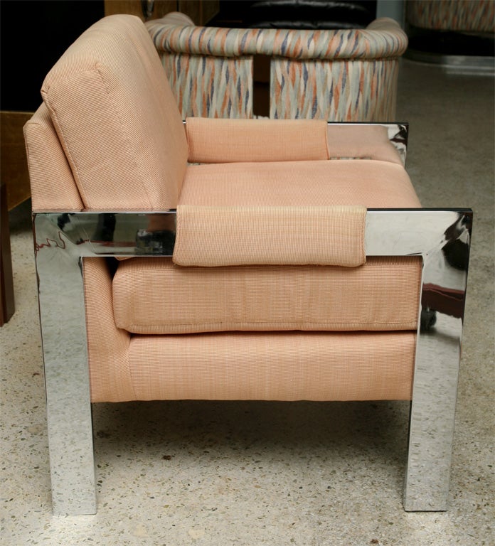 The fully upholstered seat within flat square legs and arms.
