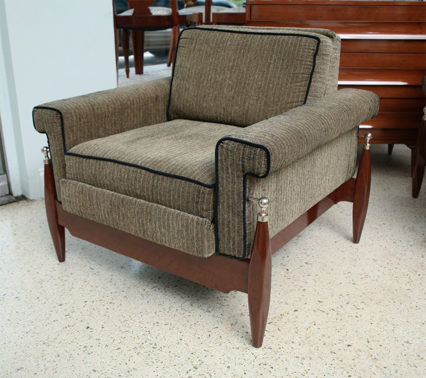 The upholstered seat on a rosewood frame accented with nickel caps and balls.