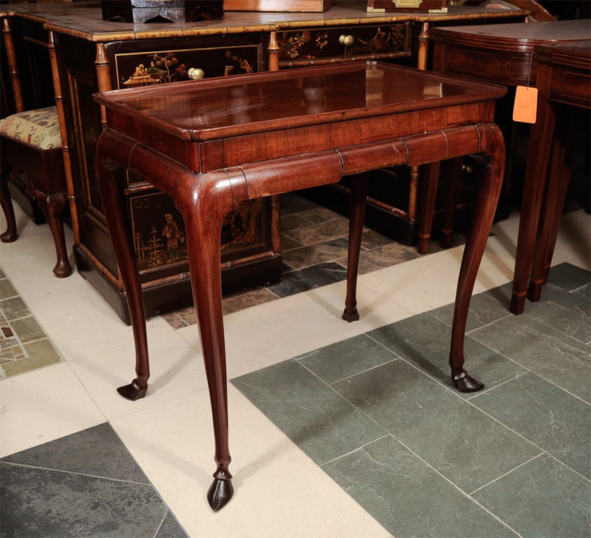 Fine and rare Queen Ann mahogany tea table with tray top, incut corners on unusual hoof feet.