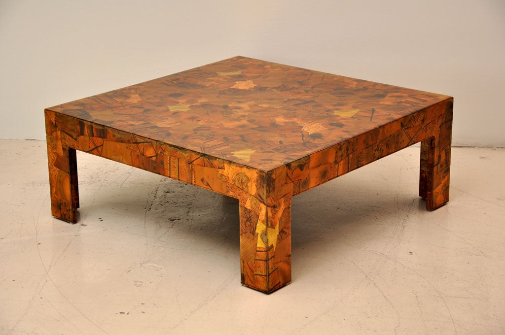 Square coffee table crafted from distressed copper sheets with a protective clear resin top coat.