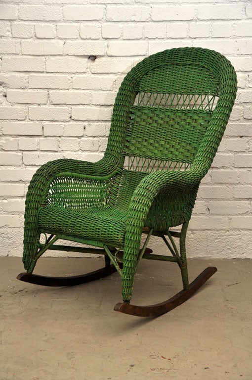 Sturdy wicker rocker with original green paint and solid wood rockers.