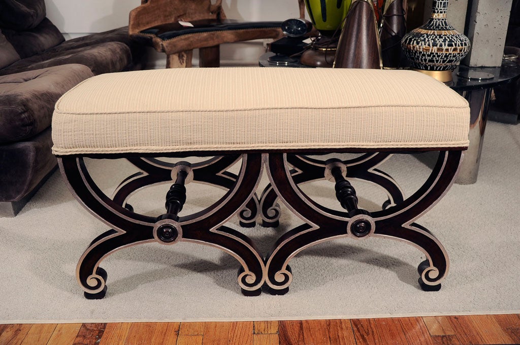 A small continental upholstered bench with scrolled double 