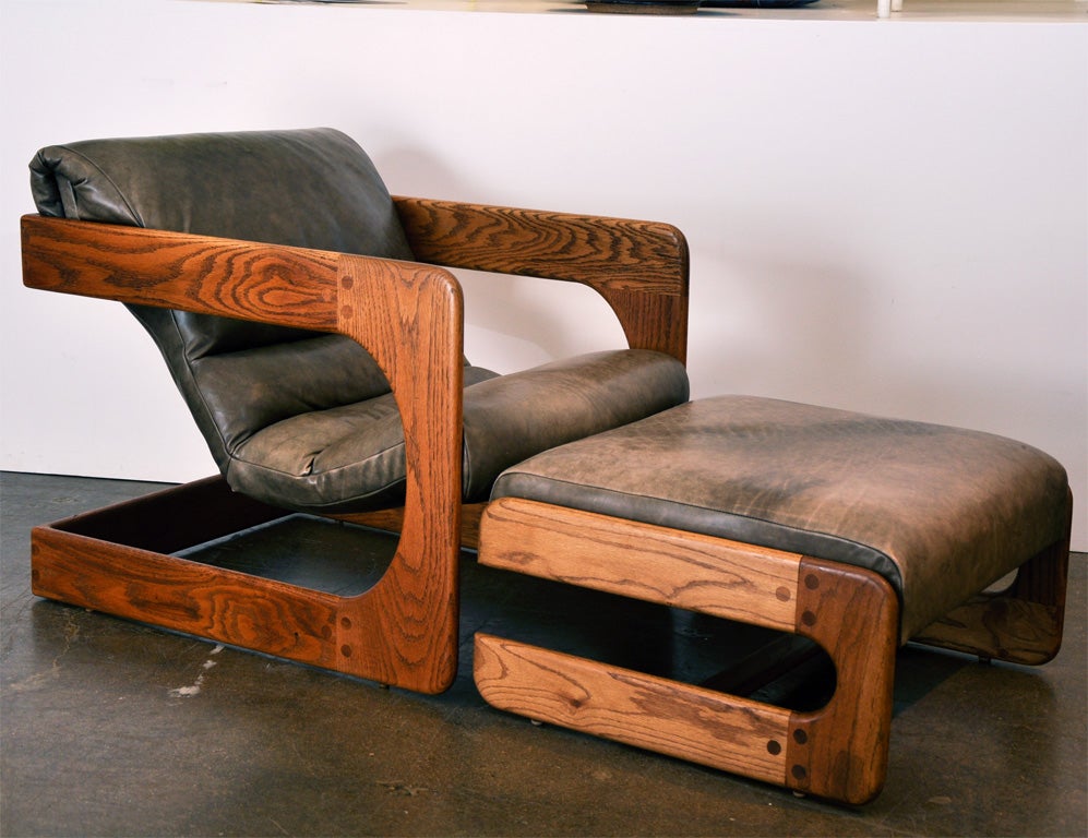 Cantilevered lounge chair with matching ottoman in oak with original naugahyde upholstery by Lou Hodges for California Craft, San Diego.