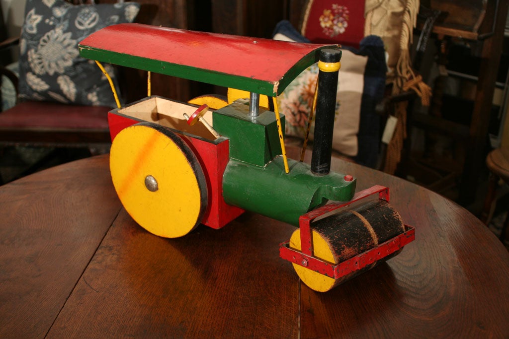 Wooden and steel painted toy steam roller. Paint is original with some refurbishing.
