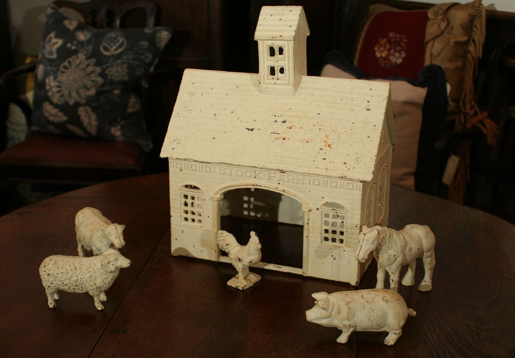 Iron Barn with a collection of five barnyard animals including a rooster, cow, horse, pig and a sheep. Original paint.