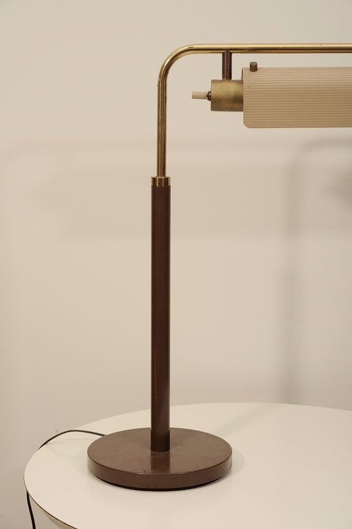 Adjustable, cantilevered table lamp by Gerald Thurston for Lightolier, produced c. 1952.  Based on machine age designs by Peter Pfisterer and William Lescaze, the lamp has an armature that adjusts up and down and pivots, and a corrugated sheet metal
