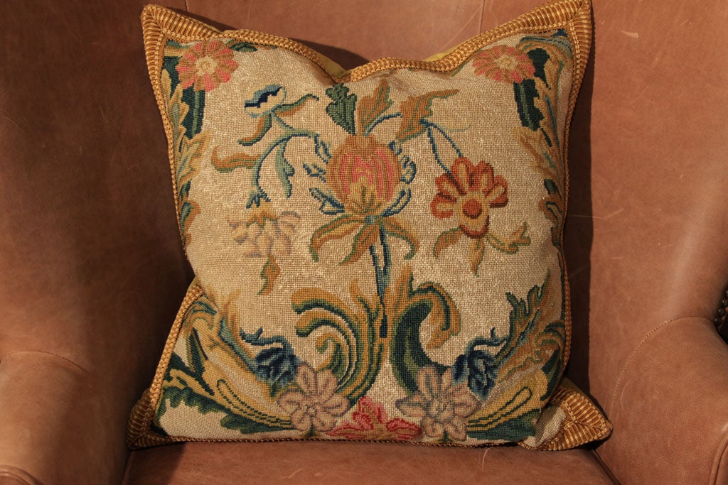 wonderful 19th century needlepoint pillow.  New construction on pillow with tape and velvet backing.  Beautiful colors and ornament.  Some repair done on the needlepoint in France.  Very sturdy, this is not delicate.