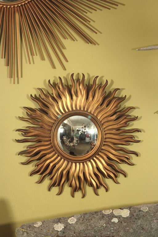 A very literal interpretation of the classic sunburst mirror with the original convex mirrored glass