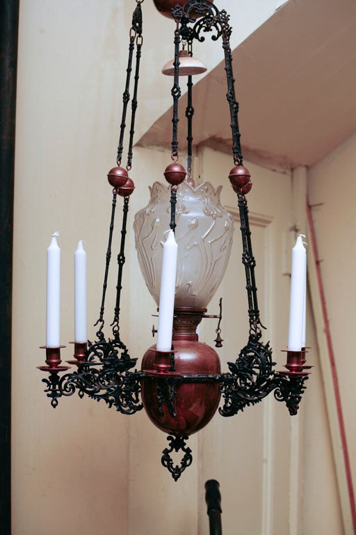 Scandinavian oil-lit  chandelier, late 19th century, in copper and iron, with arms  for candles, counterweighted for easy lighting.