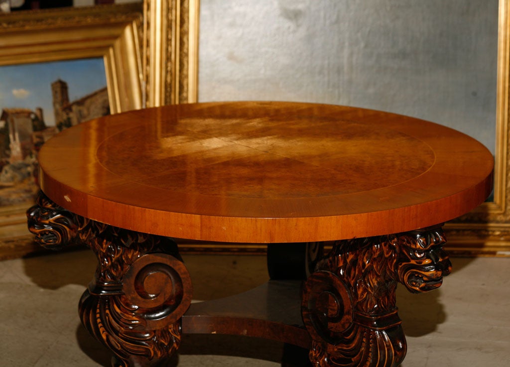 Swedish coffee or center table from  1930's, the top in crossbanded birch and alderoot, with tripod base of carved griffins