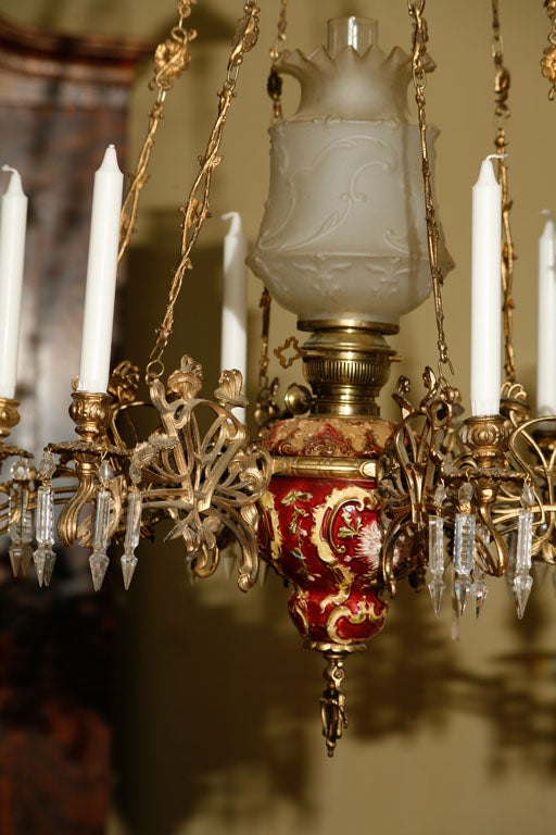 Swedish Chandelier, for oil and candles, in majolica, with gilt metal arms of intricate design, crystals, and elaborate weighted chain mechanism for lowering and raising.  Circa 1880s.