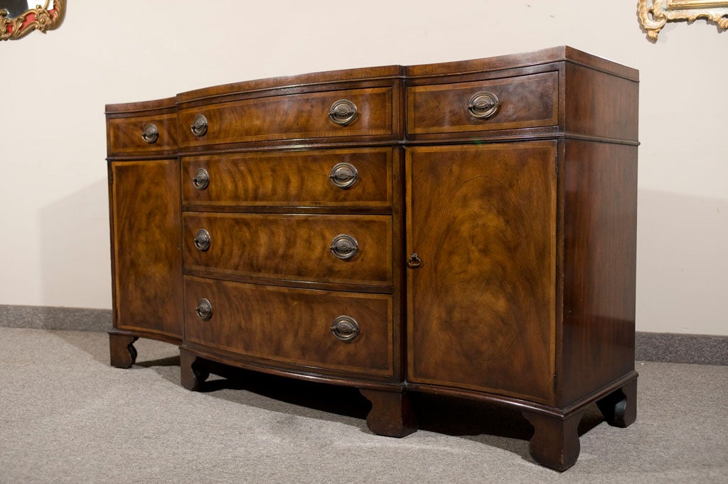 Made by one of the most respected furniture companies of all time, this buffet made by Baker Furniture is a classic example of North Carolina furniture at its best. Fine detailed banding, quality craftsmanship and the highest quality materials adorn