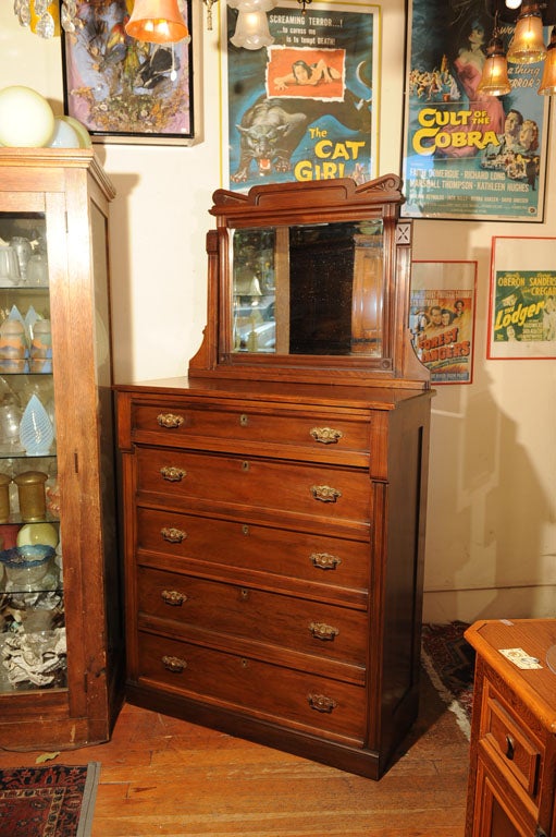 Very handsome and large American walnut Eastlake highboy with 5 drawers with original handles and original beveled glass mirror.  This very deep and well made dresser will hold lots of clothing.  This dresser is so well made you can open and close