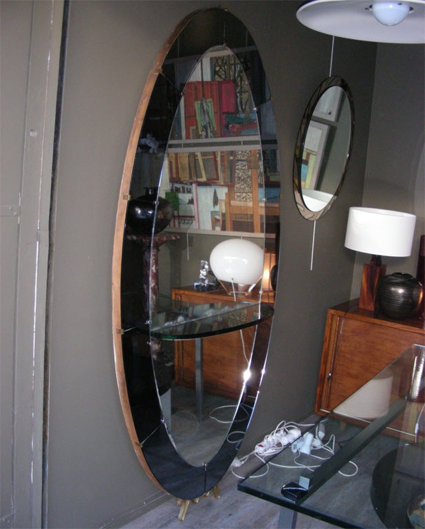 Exceptional and large 1960s mirror by Fontana Arte, framed in Fontana Arte blue mirror, base in gilt bronze.