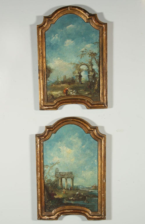 A pair of small oil on canvas landscape paintings in the manner of Guardi with their original gilt wood frames.  Probably Grand Tour acquisitions.