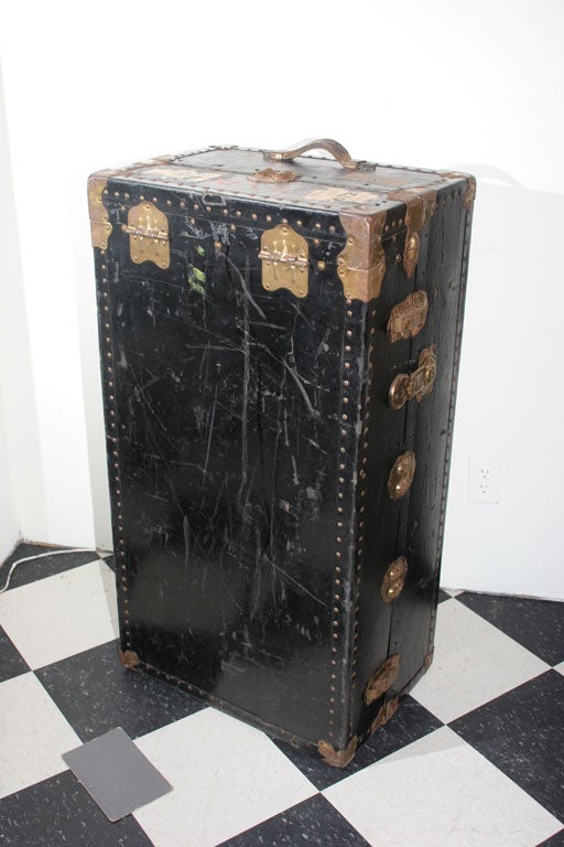 A leather covered black Swedish trunk with 