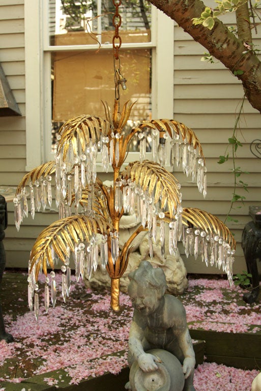7 PALM FRONDS EMITTING FROM THE CENTER, EACH WITH CRYSTAL  DROPS AND LIGHT SOCKETS UNDERNEATH THE FRONDS. ASSYMETRICAL DESIGN