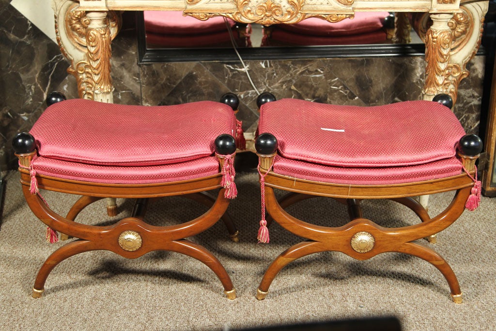 A fine pair of 'X' style Jansen benches mahogany with paint and <br />
gilt accents.  Pink Upholstery with matching tassels.