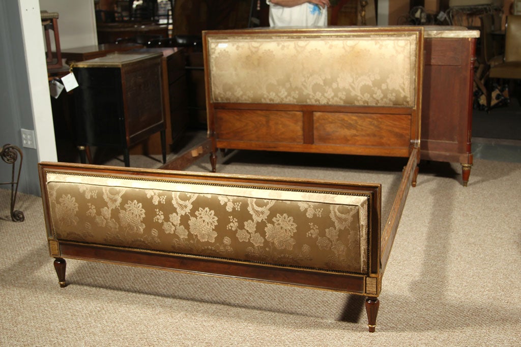 This is a wonderful full size headboard and foot-board with matching rails. Louis XVI style with very fine gilt design. The fabric and stuffing are all new. Stamped Jansen.