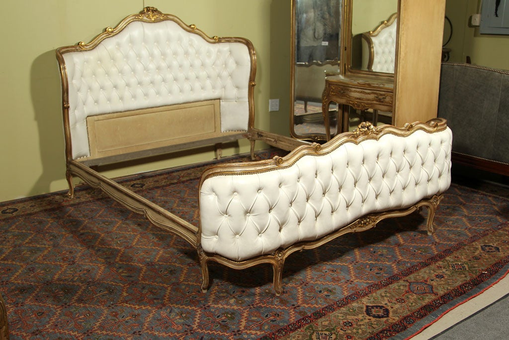 Fabulous Stamped Jansen Queen Size Head and foot board bed frame in white leather, all tufted.  The wood has gold leaf high lights. Louis XV.