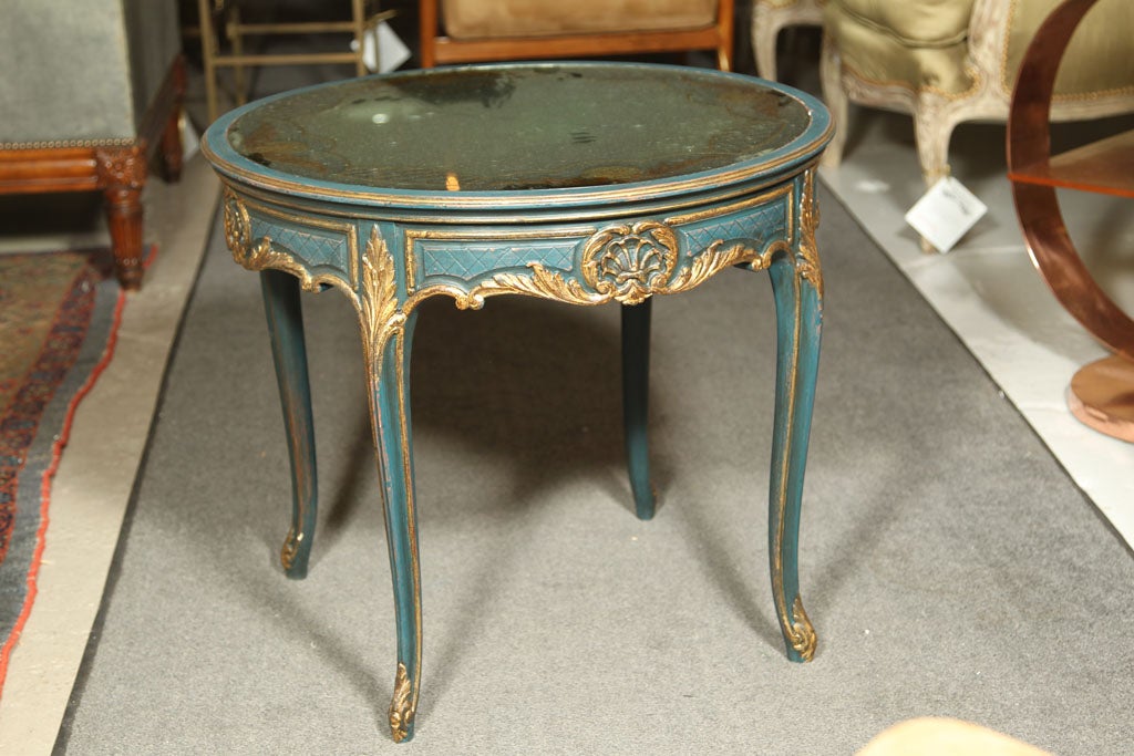 Wonderfully original paint decorated centre table by Maison Jansen. Eglomise design mirrored top sitting on a Louis XV style green and gilt gold paint decorated table. Fine original condition.