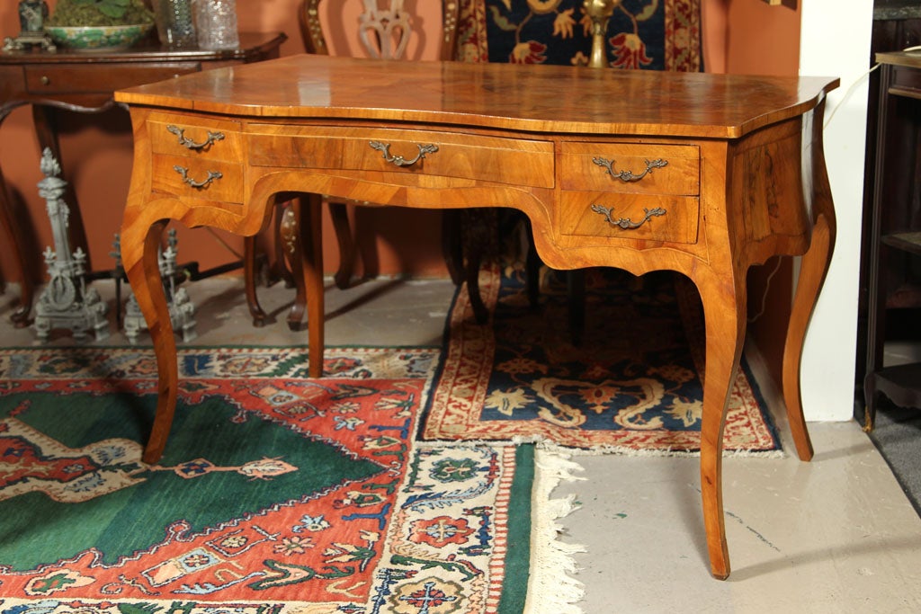 Italian Olive Wood Bombe' Desk with center drawer and 4 side drawers.  Fabulous legs and patina.