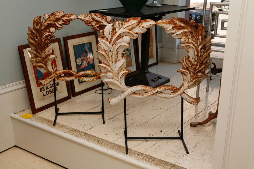 Boldly Graphic Architectural Iron Wreaths placed on Removable Stands  . Original Painted Surface with Nice Signs of Age