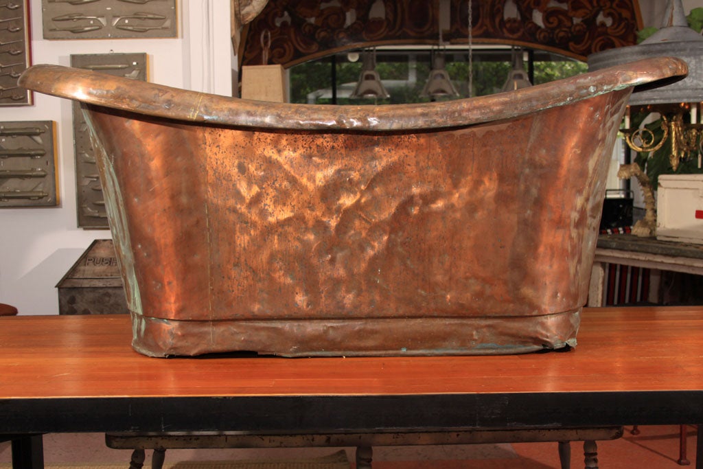 Perfectly aged Copper Bathtub with a fully rolled edge and deep-profile racetrack-shaped base.