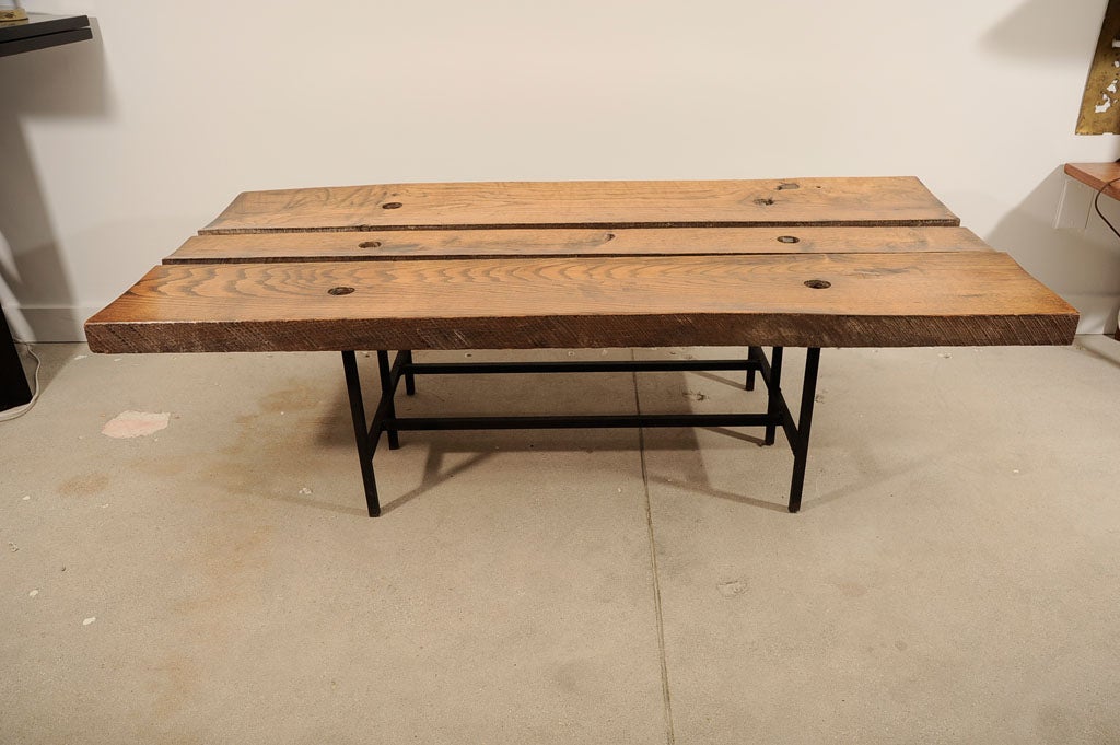 Massive coffee table of hewn wood and wrought iron by artist/blacksmith Harry Balmer, produced for a residential commission in Flemington, NJ, c. 1964.  Balmer worked as a welder, sculptor, and furniture designer in the New Hope orbit of Paul Evans,
