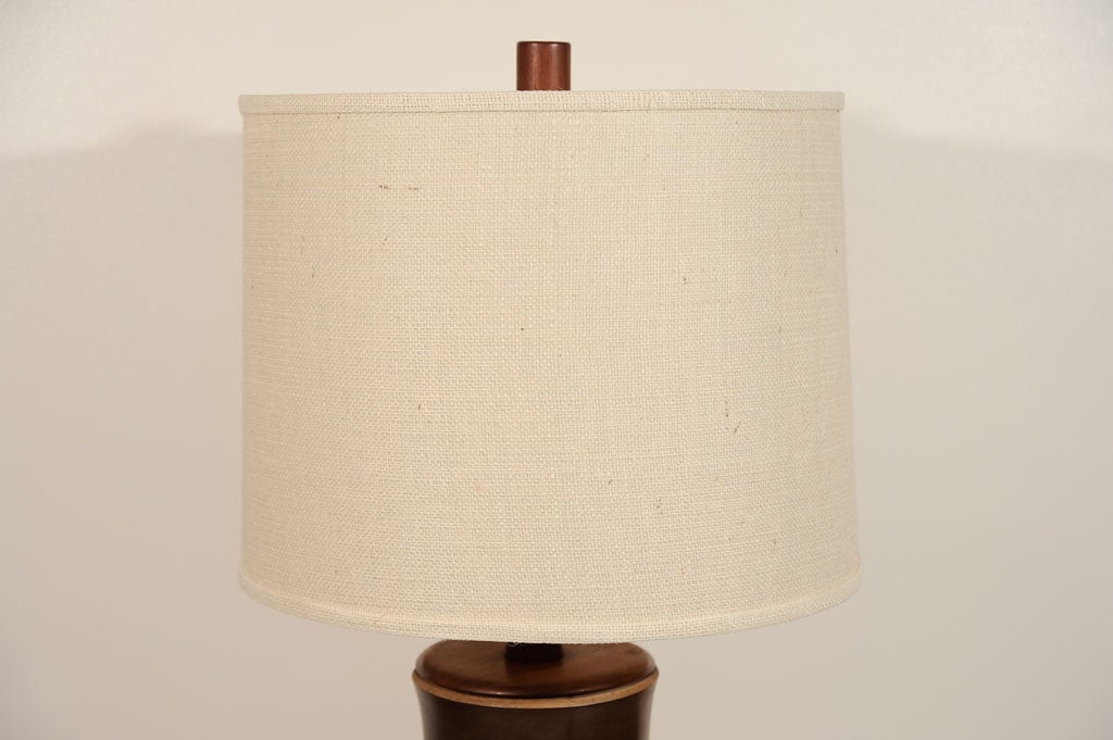 Grand scale pair of lamps composed of ceramic bamboo sections divided by walnut spacers resting on walnut bases by Gordon Martz with new custom burlap shades.