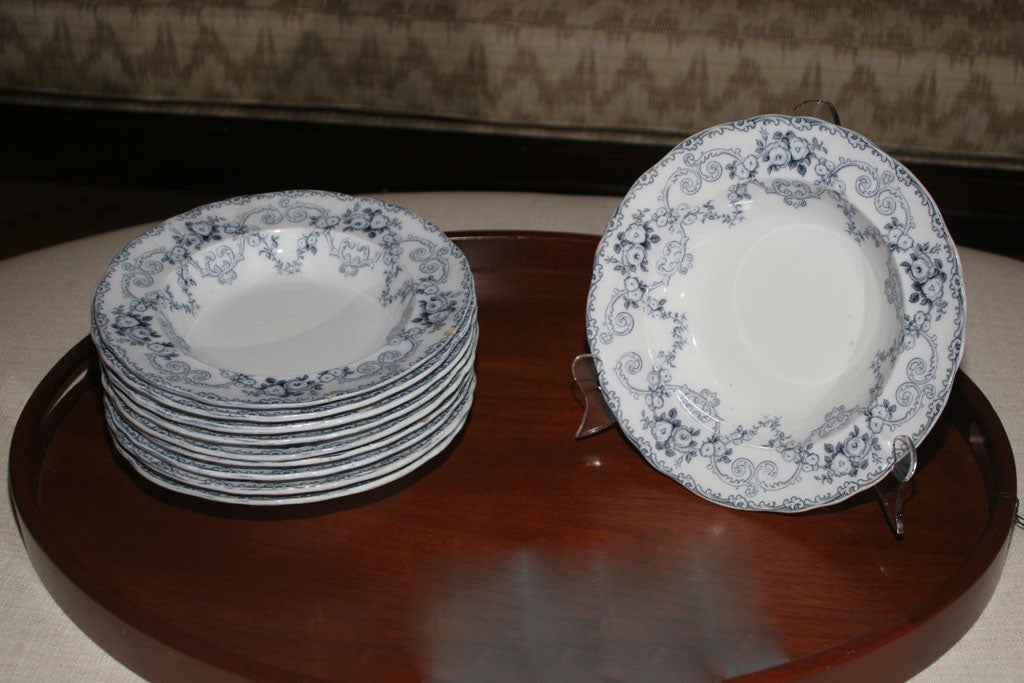 Set of porcelain dinner bowls with queen's blue floral pattern around rim.