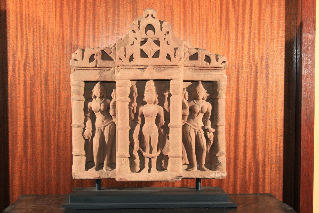 Exceptional pink sandstone carving from Northwest India. This finely executed carving depicts the Hindu deity Vishnu flanked by two consorts, presumably Lakshmi and Sarasvati. Vishnu is regarded as the 