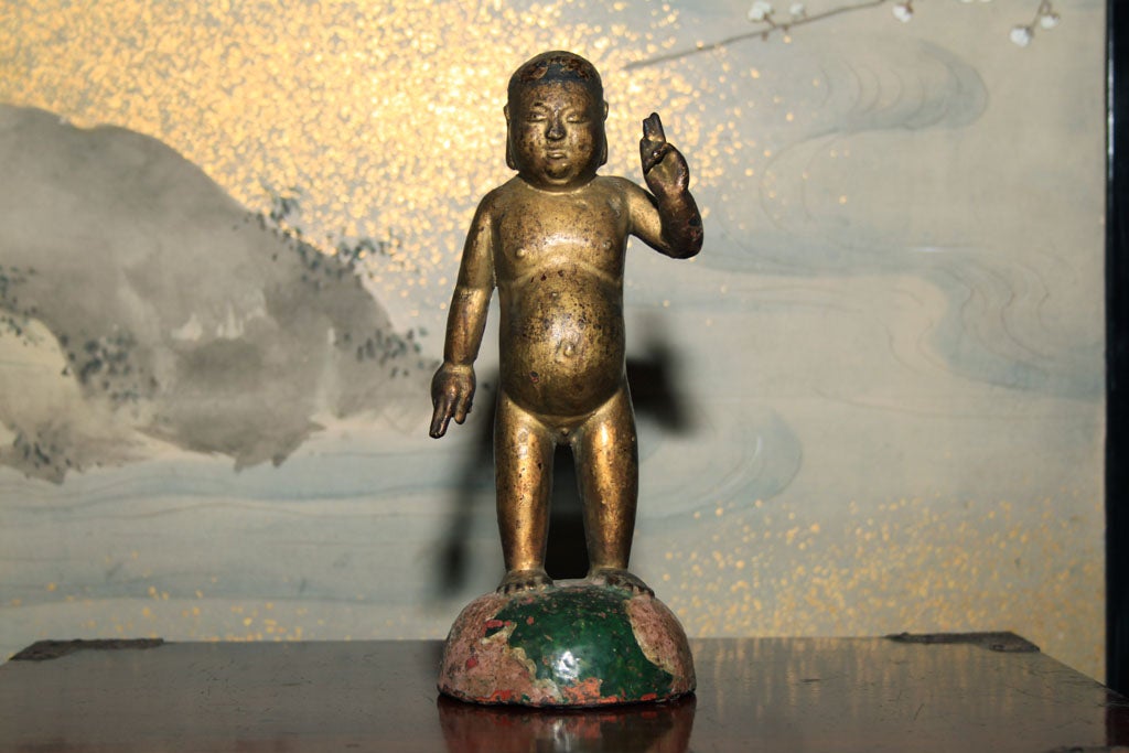 Vietnamese cast bronze image of the Guatama Sakya-muni Buddha or the princely Siddartha, as an infant. The Buddha seen as a standing infant with one arm stretched towards heaven the other towards earth takes possession of all that is material and